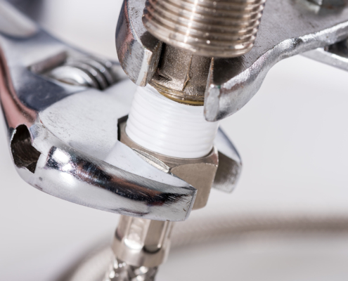 Plumber screwing plumbing fittings